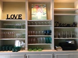 Nice collection of glassware. Pink depression, green hobnail teacups, heavy dark green water & juice glasses, black stem, green stem ....