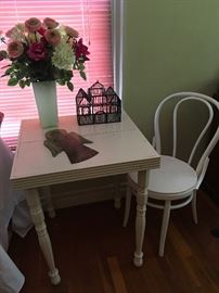 Nice little wood table and ice cream parlor chair.
