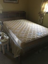full size bed and box springs, wooden headboard with storage, and footboard