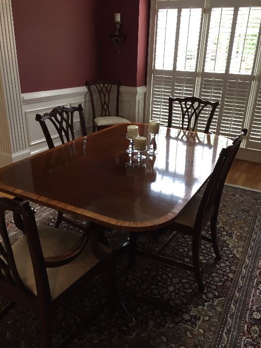 Dining room table. Measures about: 104" long, 44" wide. Includes two leaves and pads.