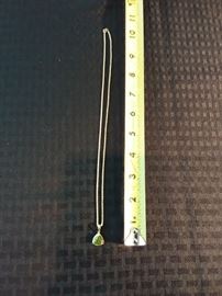 Green stone and gold pendant on 14k