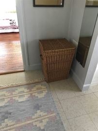 wicker laundry basket and kilim rug