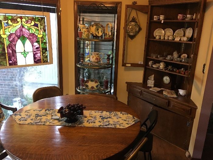 Antique oak table; baker’s rack with custom- cut glass shelves. 