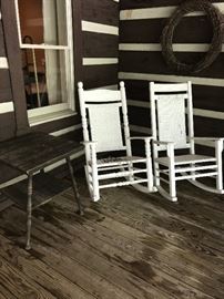 5 wood porch rockers of various styles.