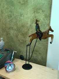 Counter weightedmetal rocking cowboy and horse.