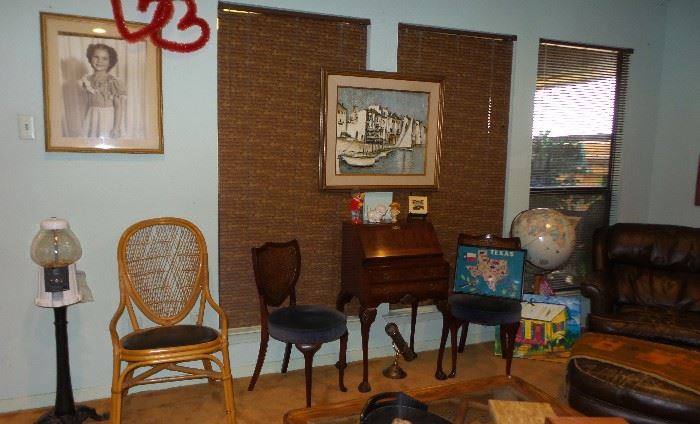 small antique secretary, chairs. Gumball machine. Globe, leather club chair. 1950s framed art 