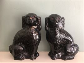 Pair antique Jackfield pottery spaniels with glass eyes (one with chipped nose)