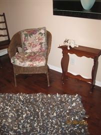Wicker Chair with Cushions, Small Antique Side Table assumed to be oak, Contemporary Rug