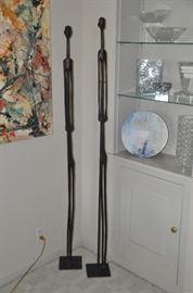 Pair of authentic carved wooden Tanzanian Stickmen. One is 58” high and the other is 61” high.