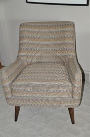 One of the two Quinn Room and Board upholstered chairs covered in a gray, cream and caramel hounds-tooth fabric. 29.5” w x 34” h x 28”d.