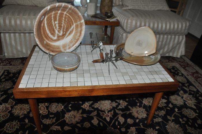 Mid century white ceramic tiled walnut coffee table.  30” x 15”h x 18”d. Shown with signed pottery pieces