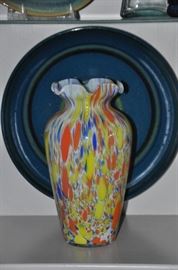 Fantastic large colorful glass vase shown with a large round pottery platter