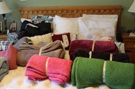 King size wooded headboard bed and linens