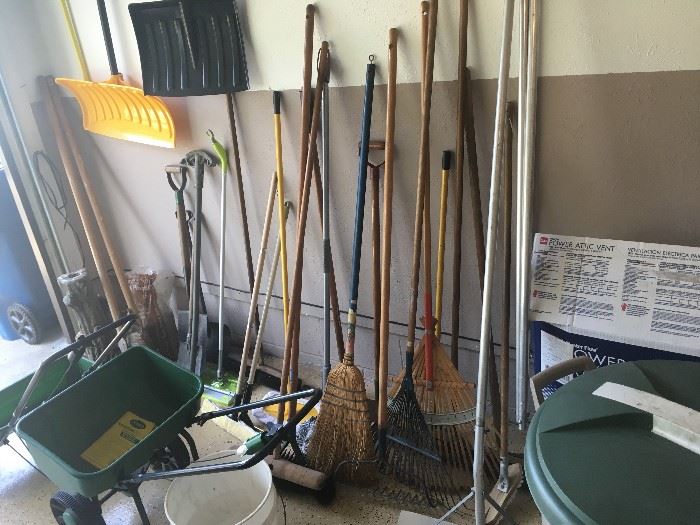Many brooms and shovels