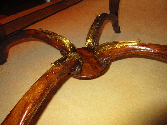  Detail of large glass-top coffee table with brass ornaments 