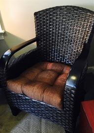  Rattan chair with ebony finish and wood trim detail with seat cushion
