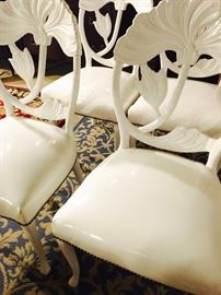 Set of four, white designer chairs with white leather upholstery and nail trim detail