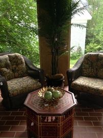 The sun room is the perfect sport for the swivel wicker chairs and artificial palm tree.