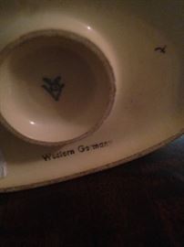 The name Hummel in German means bumblebee, and the V stands for “Verkaufsgesellschat” or Distribution Company.