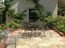 A settee and round table with 4 chairs provide more seating in the garden.
