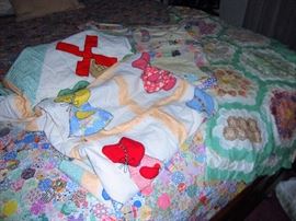 THERE ARE SEVERAL VINTAGE QUILT TOPS AT THIS SALE