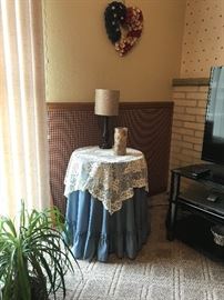 Draped corner table with lamp and accessories