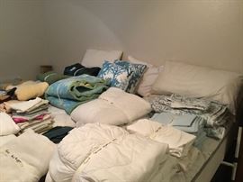 Lots of bed linens - sheets, comforters, pillow cases, pillows and blankets  