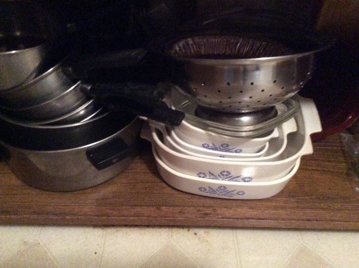 many kitchen pots, pans, and Corning