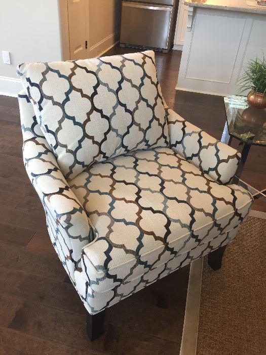 one of two upholstered club chairs