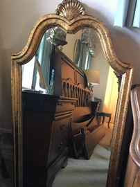 Two gold leafed, arched top mirrors