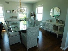 dining room with glass table, crate and barrel chairs and distressed mid-century buffett