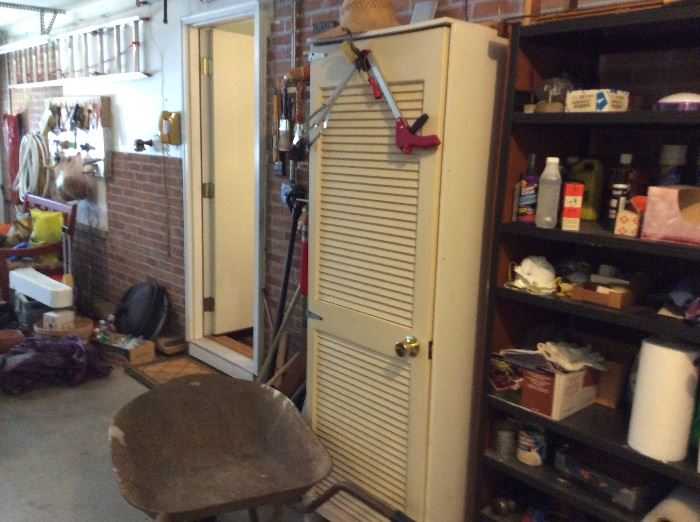FREE STANDING CUPBOARD, WHEEL BARROW, AND A GARAGE FULL OF TOOLS