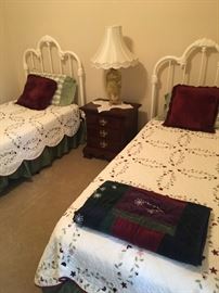 Twin wrought iron beds with side table. 