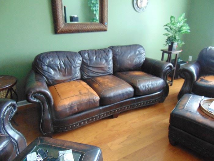 Leather sofa and two side chairs.  Worn look