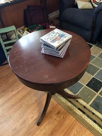 mahogany round table. three legs with a drawer