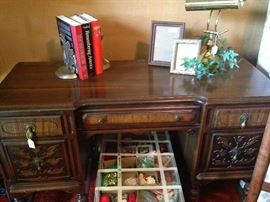 Antique desk; books; frames; desk lamp; below -  Christmas ornaments