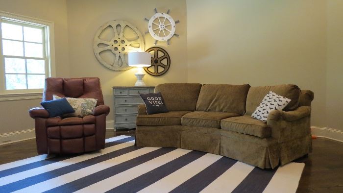 Kids Playroom sofa and leather recliner, Distressed blue console, nautical wall wheel decor, nautical area rug 