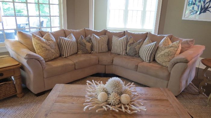 Living Room Beige Sofa - microsuede with throw pillows, distressed wood coffee table and side table