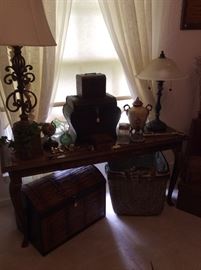 Mahogany sofa table, lots of leather and wicker storage baskets
