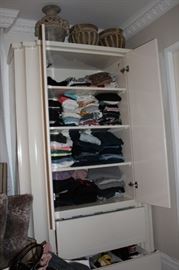Armoire  has Lots of Clothing Inside, with Decorative Urn and Pots