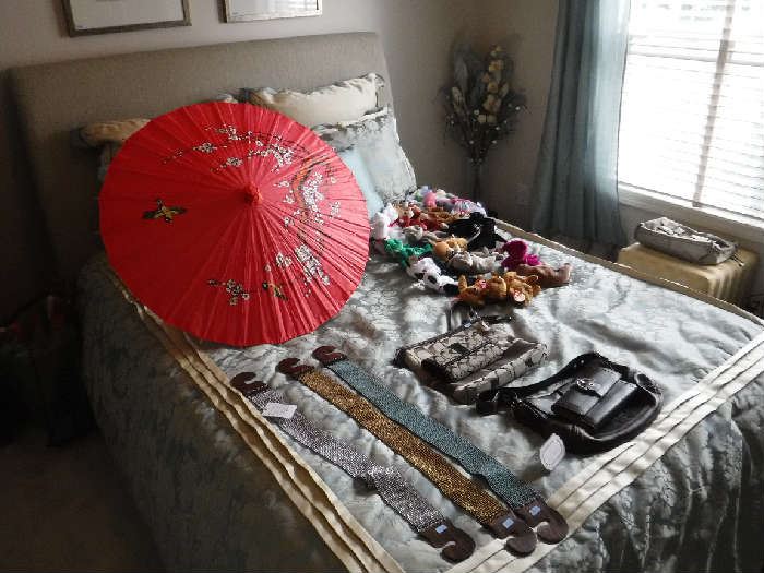 Queen bed covered in fabric on all 4 sides. The comforter/pillow and curtains are all for sale as a single package. We have many parasols that were used (as were some of the lamps) to decorate for a wedding which Miss Sherry designed.