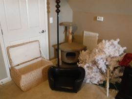 A very cool clothes basket, the dark thing at the center is a small dog leather bed you just have to get! We have a nice white Christmas tree (that needs a stand) and also a high like new cat scratching tower!