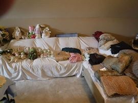 The couch which is not for sale is holding a selection of fine Easter Bunnies and some of the linens and curtains we are selling