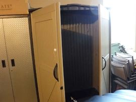 Open with no shelving for upright tools. No shelves ever came with it however there is an extra left door that could possibly be fitted