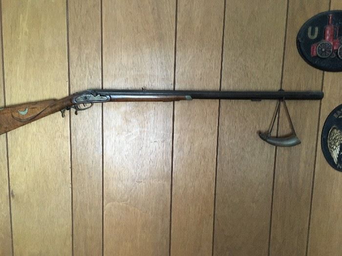 this is a vintage musket with a powder horn 