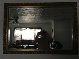 A beautiful accent mirror with beveled glass.   Goofy guy in mirror not for sale.