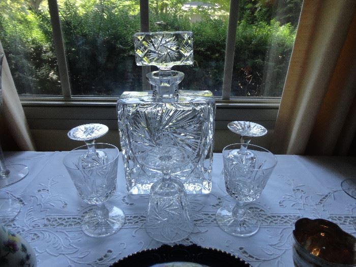 An elegant cut crystal decanter with five matching glasses