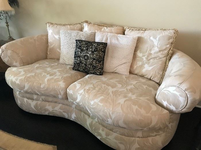 Ivory Kidney Shaped sofa. One of two