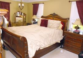 7 Piece Queen Size Bedroom Set which includes: Queen Sleigh Bed, Two (2) Night Tables, Armoire, Men's Dresser, Woman's Dresser and Mirror