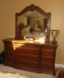 7 Piece Queen Size Bedroom Set which includes: Queen Sleigh Bed, Two (2) Night Tables, Armoire, Men's Dresser, Woman's Dresser and Mirror